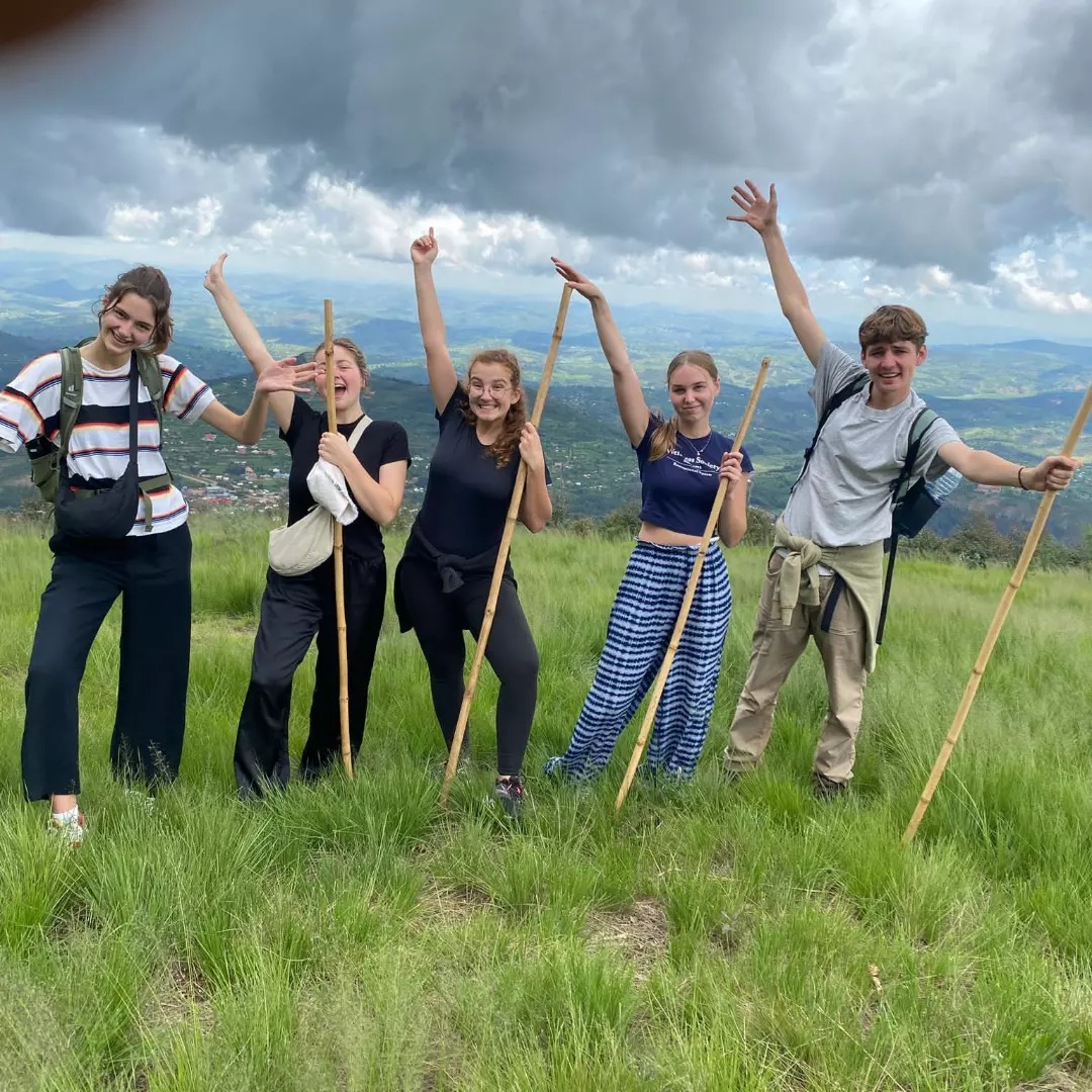 People celebrating in Rwanda landscape
